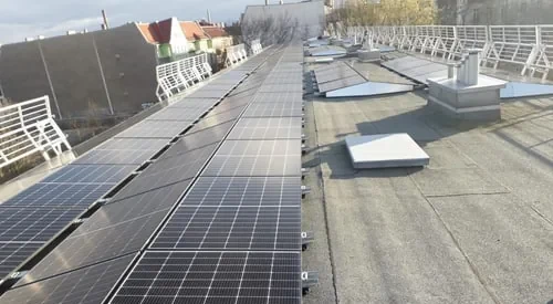 Moduli solari su un tetto piano accanto ai condotti di ventilazione
